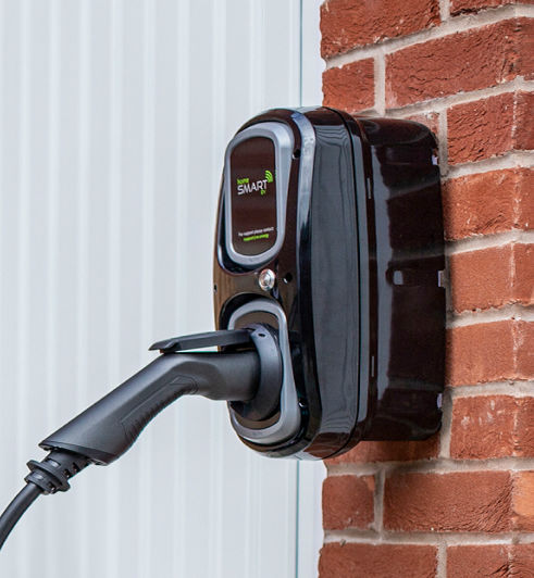 EV charging attached to a brick wall